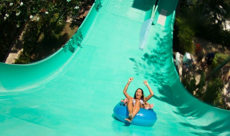 Two riders launching into the Boomerang water slide at Waterbom Bali